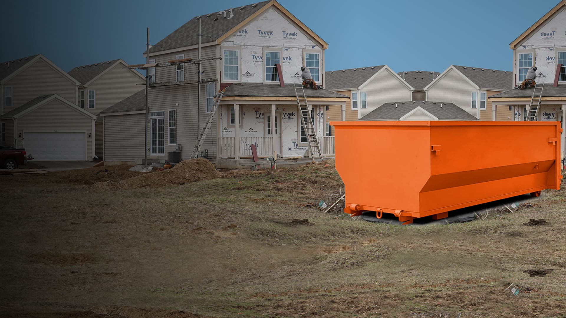 Dumpster near houses being built